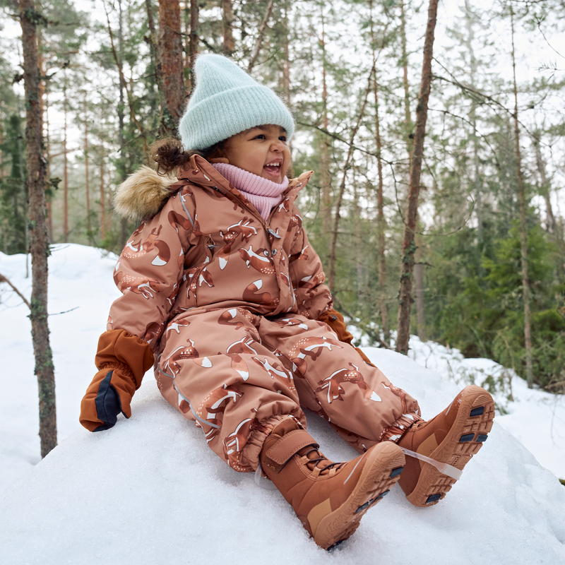 toddler playing in snowsuit