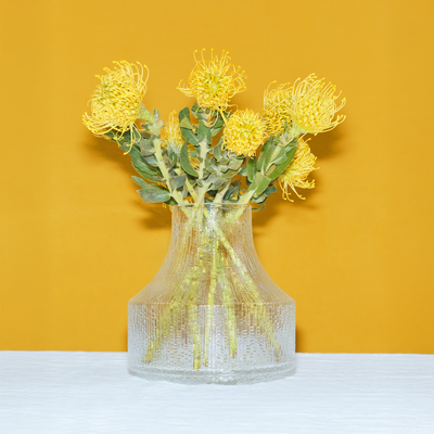 iittala Ultima Thule vase with yellow flowers